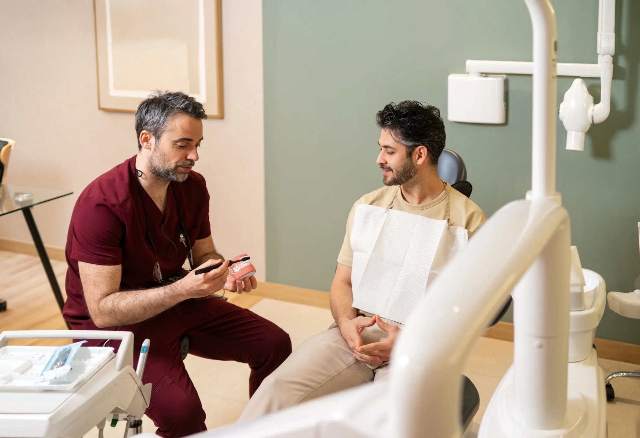Dentist explaining oral care to a patient during a consultation
