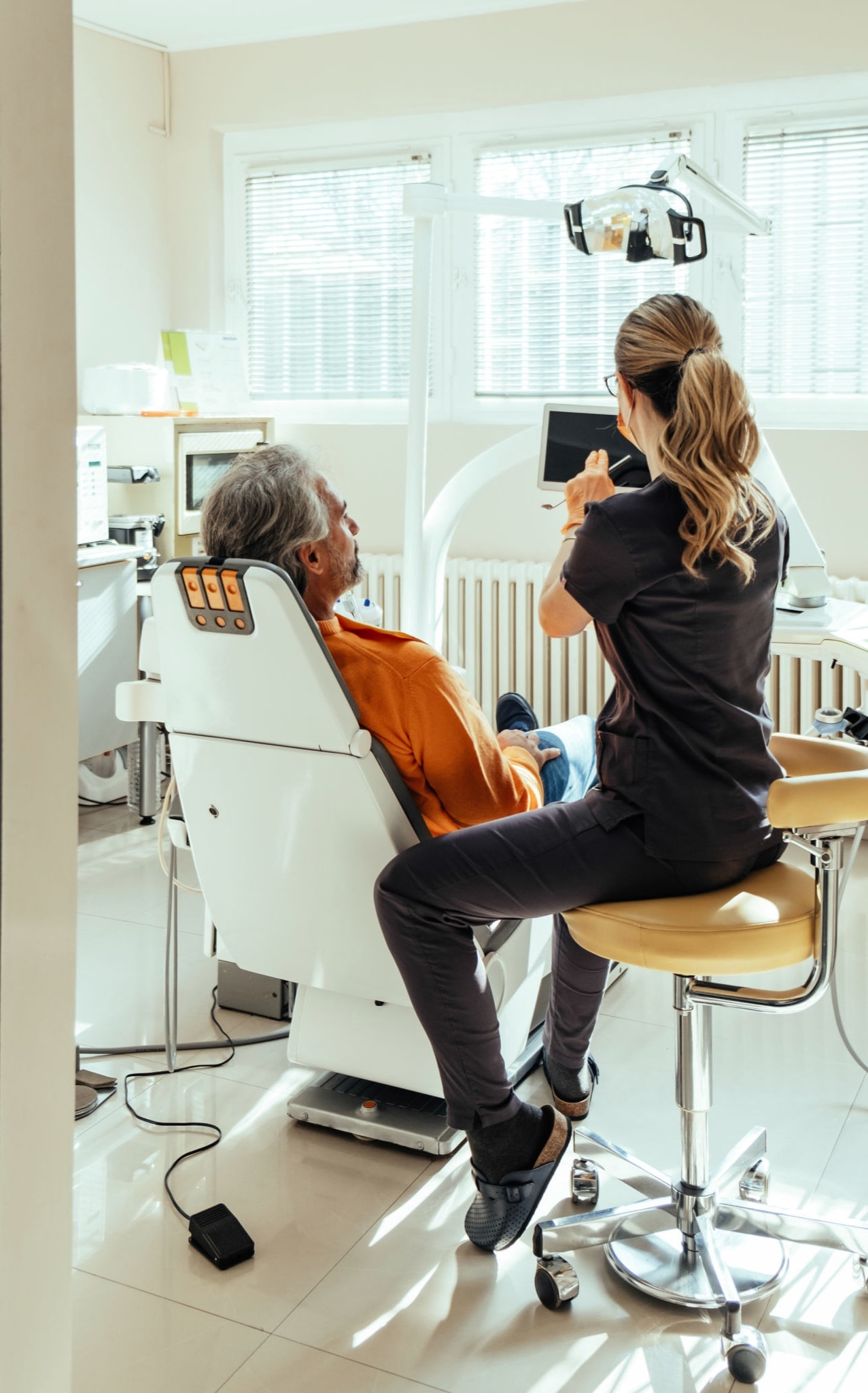 Dental professional performing a cleaning in a modern office