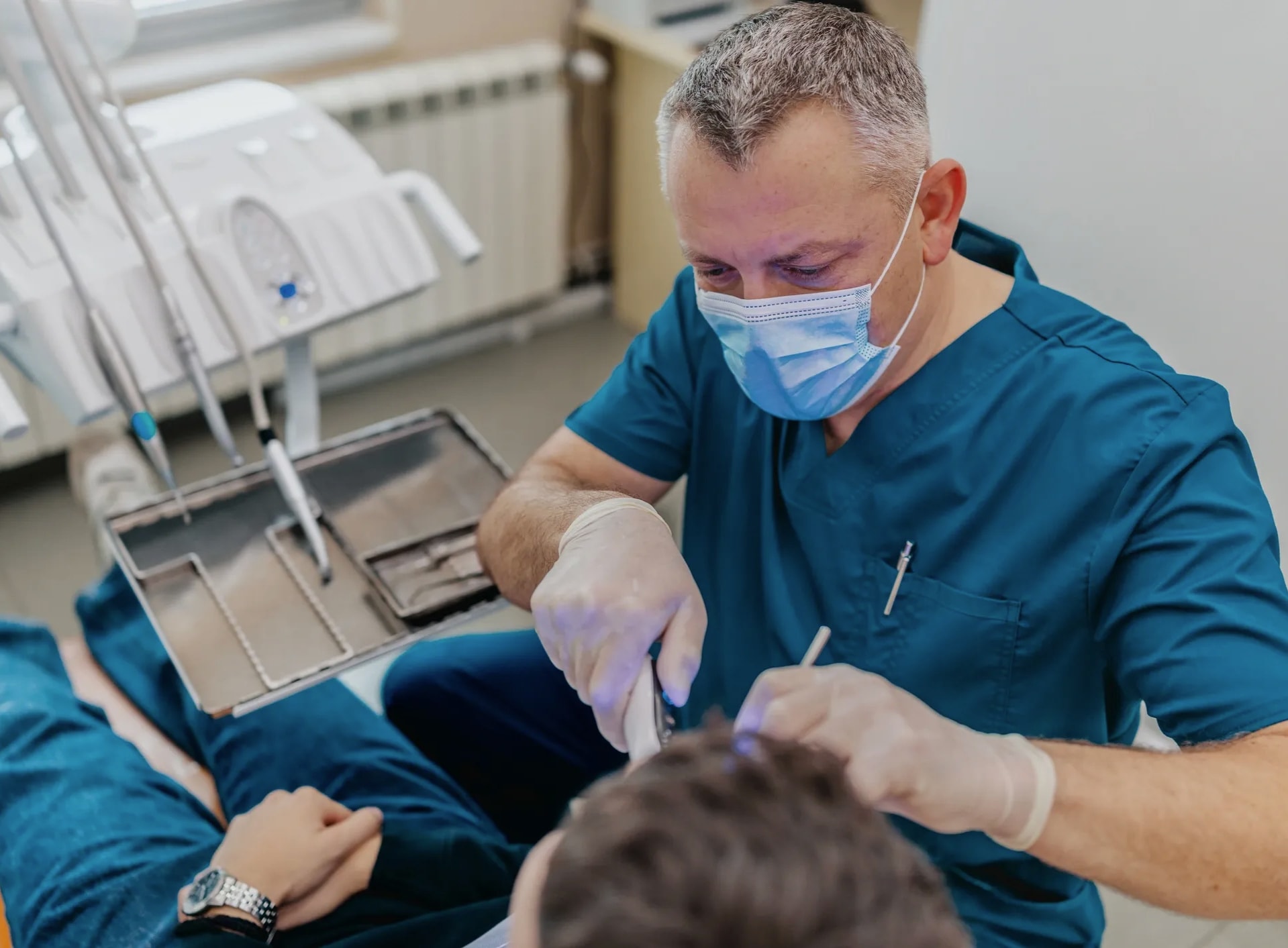 Dentist providing restorative treatment to a patient